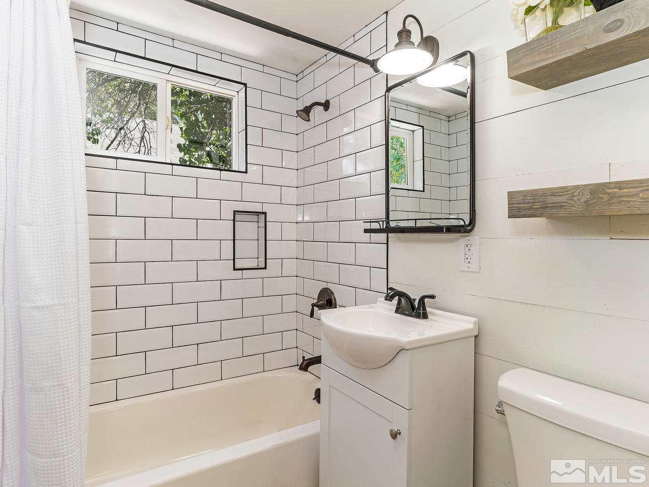 1409 Locust Street Reno, NV 89502 - Photo 10 of 16 a bathroom with a sink a toilet and shower