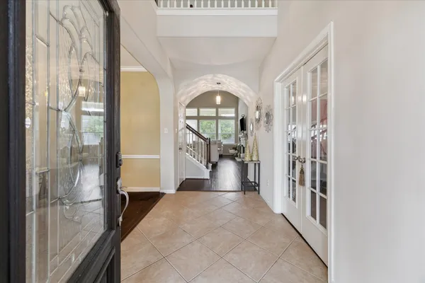 a view of a hallway with wooden floor and windows