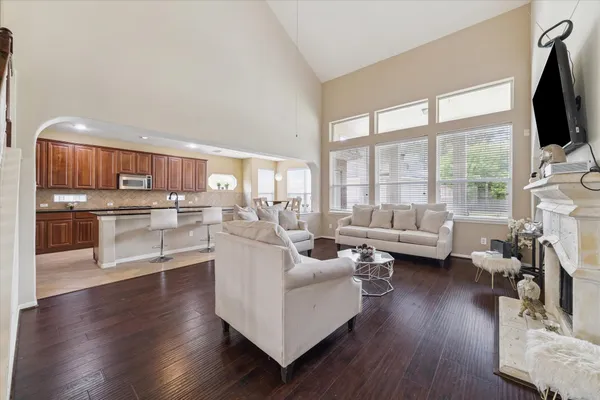 a living room with furniture wooden floor and a flat screen tv