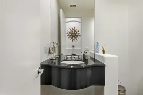 a spacious bedroom with a bed a couch and a window