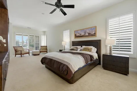 a large bedroom with a large bed and dresser