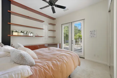 a bedroom with a bed and a flat tv screen