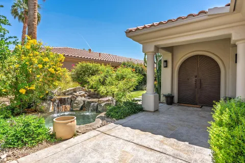 a view of a house with potted plants