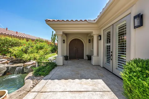 a view of backyard with seating area and green space