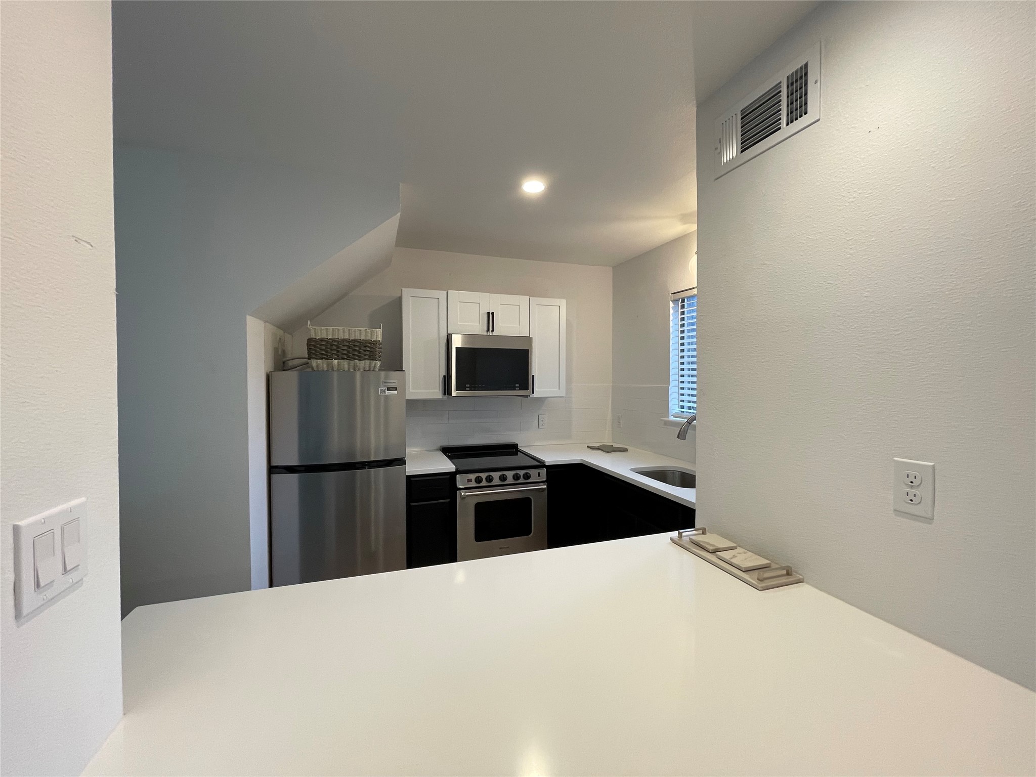 1714 Enfield Road, Unit 102 Austin, TX 78703 - Photo 6 of 15 Culinary adventures await in this functional kitchen, featuring sleek counters and modern appliances.
