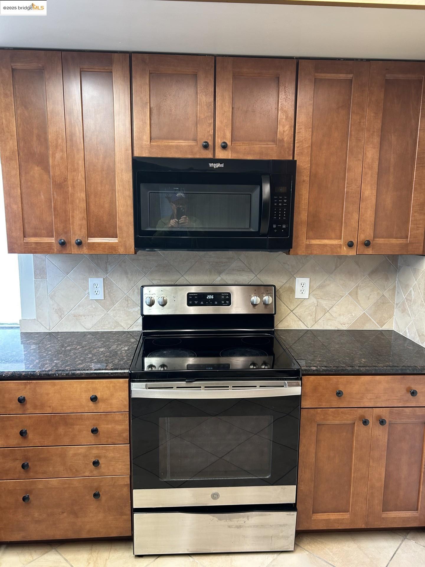 1363 Ridgecrest Road Pinole, CA 94564 - Photo 14 of 37 a kitchen with granite countertop a stove and a microwave