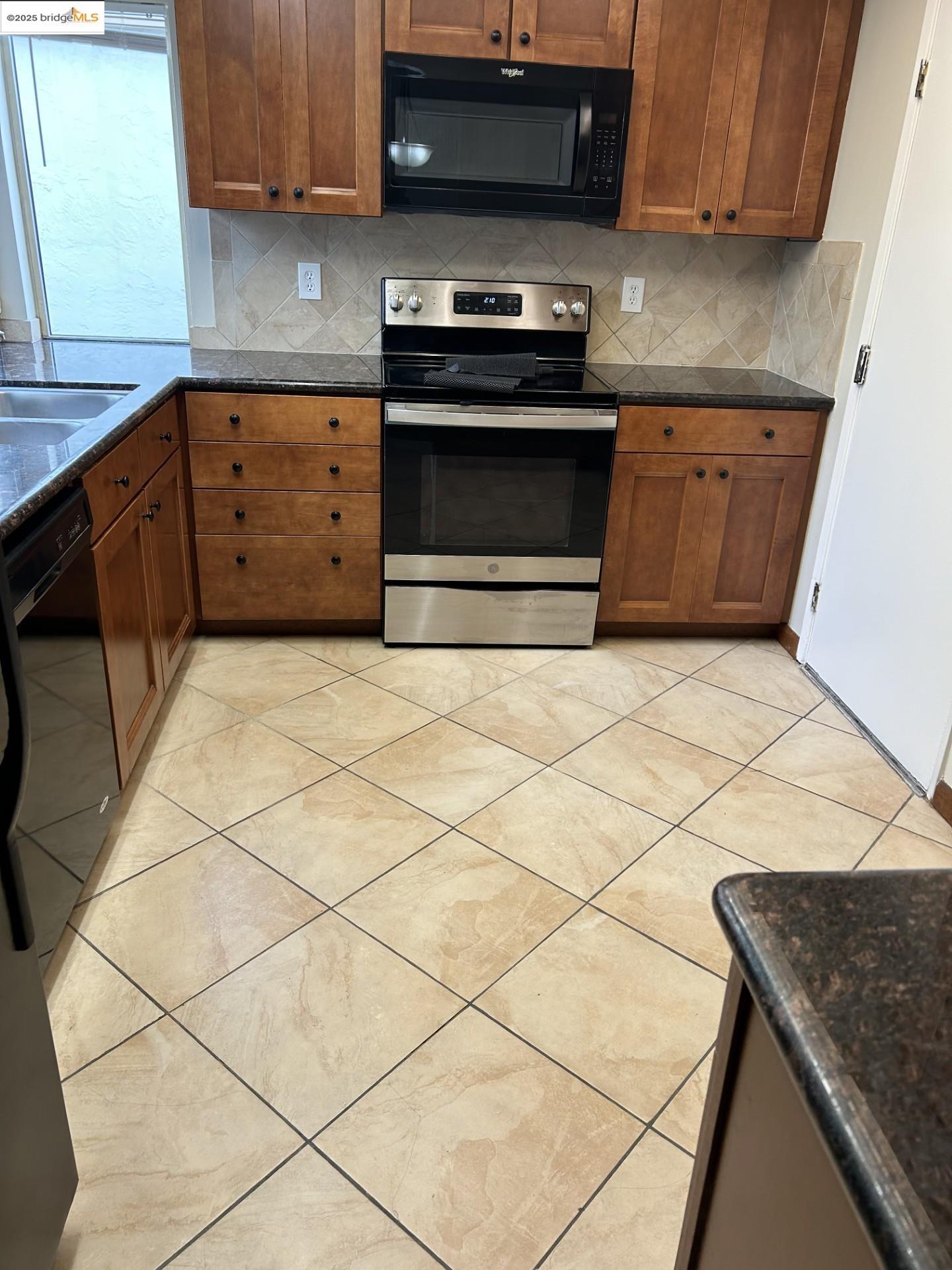 1363 Ridgecrest Road Pinole, CA 94564 - Photo 23 of 37 a kitchen with granite countertop a stove top oven a sink a counter space and cabinets