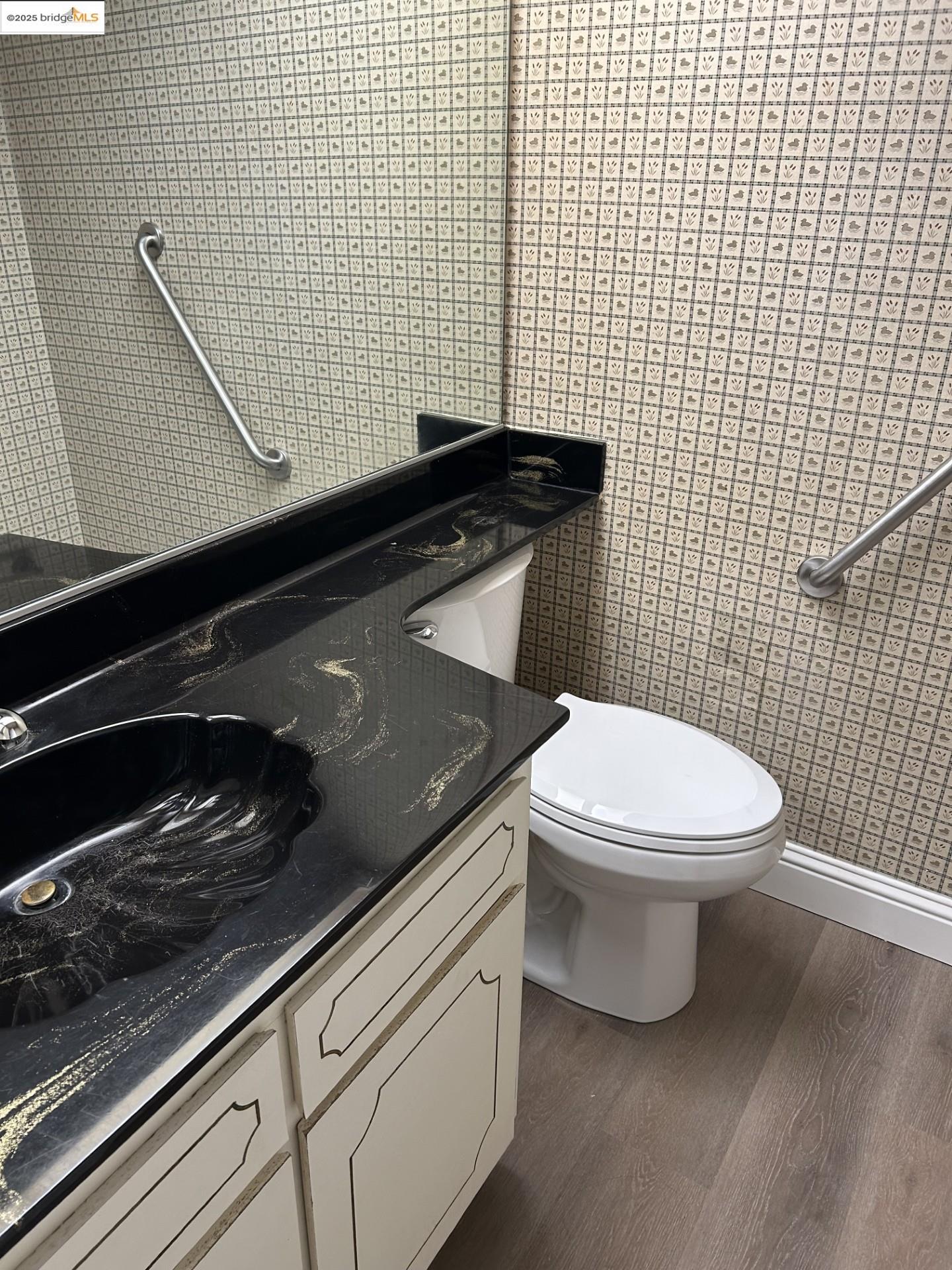 1363 Ridgecrest Road Pinole, CA 94564 - Photo 30 of 37 a bathroom with a granite countertop toilet and sink