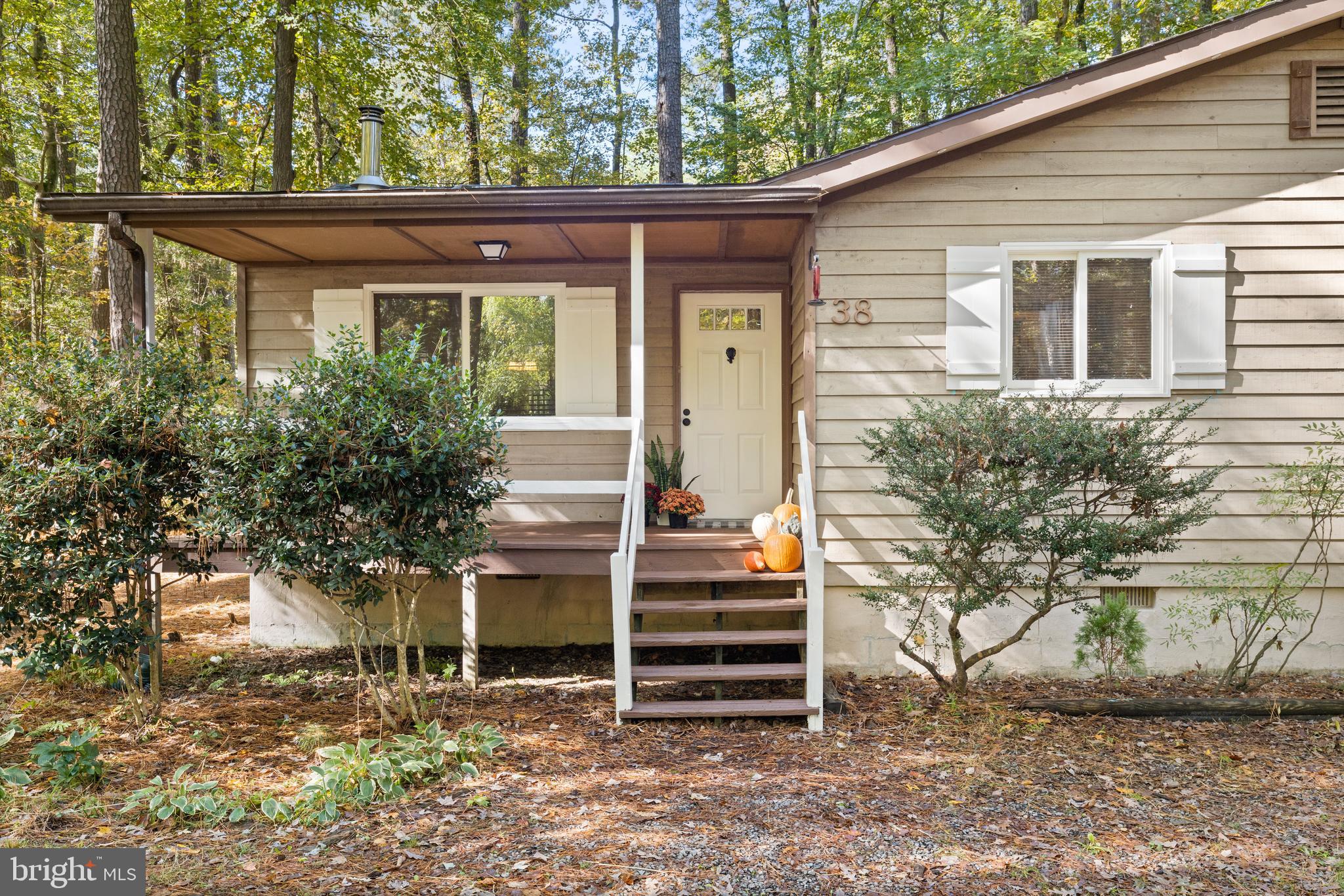 38 Canal Road Ocean Pines, MD 21811 - Photo 2 of 40 a front view of a house with a garden