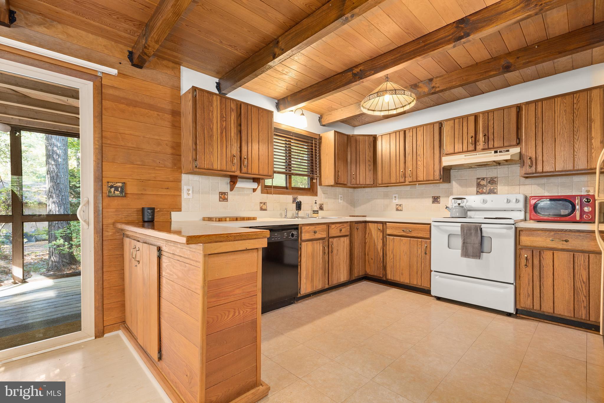 38 Canal Road Ocean Pines, MD 21811 - Photo 13 of 40 a kitchen with a sink window and cabinets