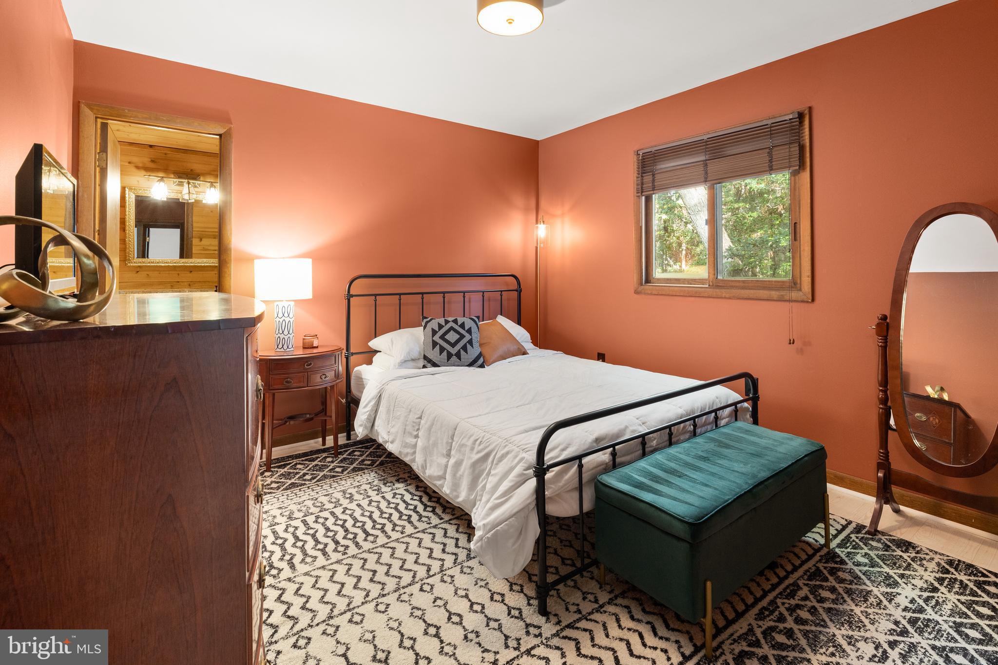 38 Canal Road Ocean Pines, MD 21811 - Photo 15 of 40 a bedroom with a bed and wooden floor