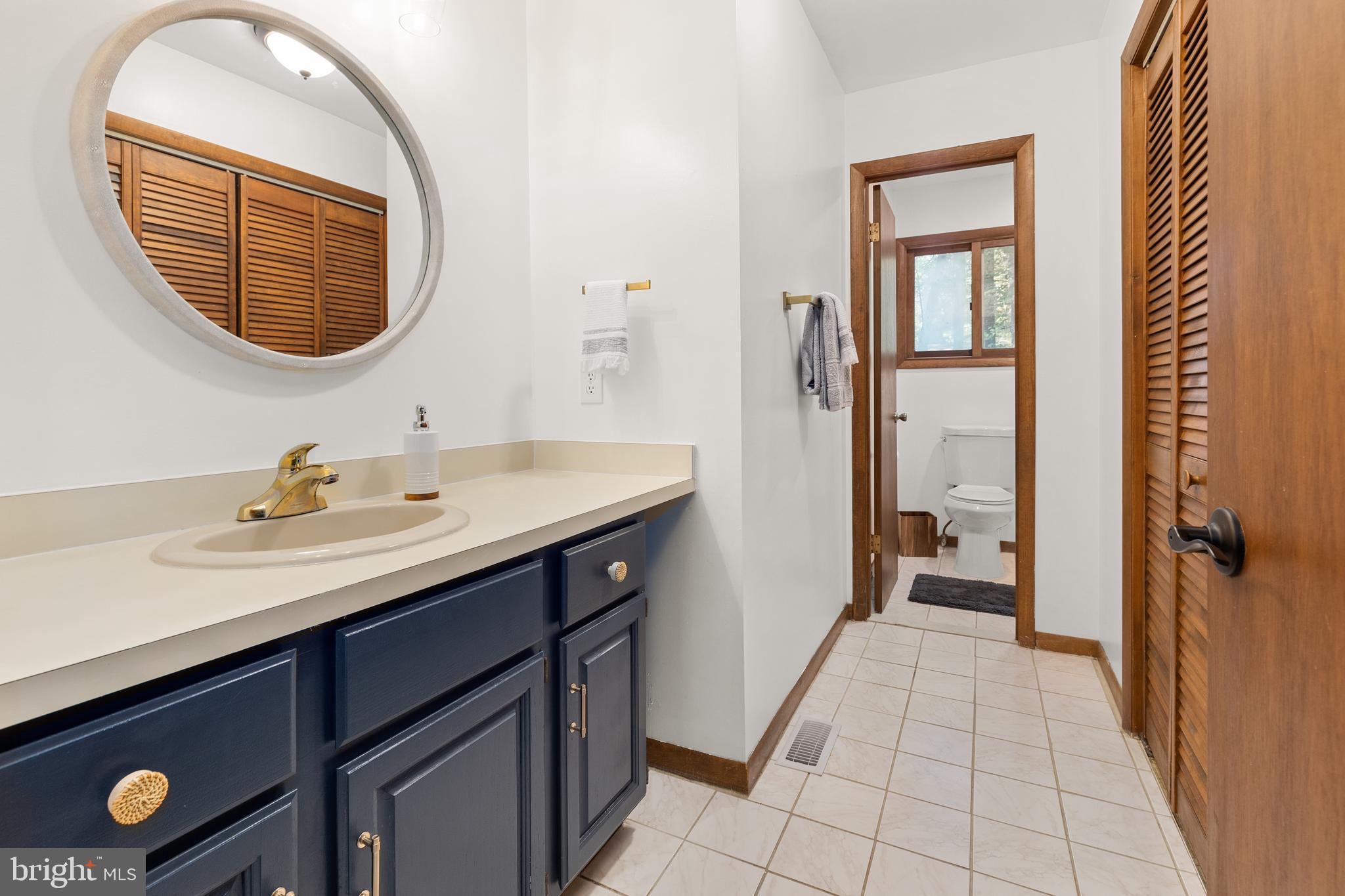 38 Canal Road Ocean Pines, MD 21811 - Photo 22 of 40 a en suite bathroom with a sink and a mirror