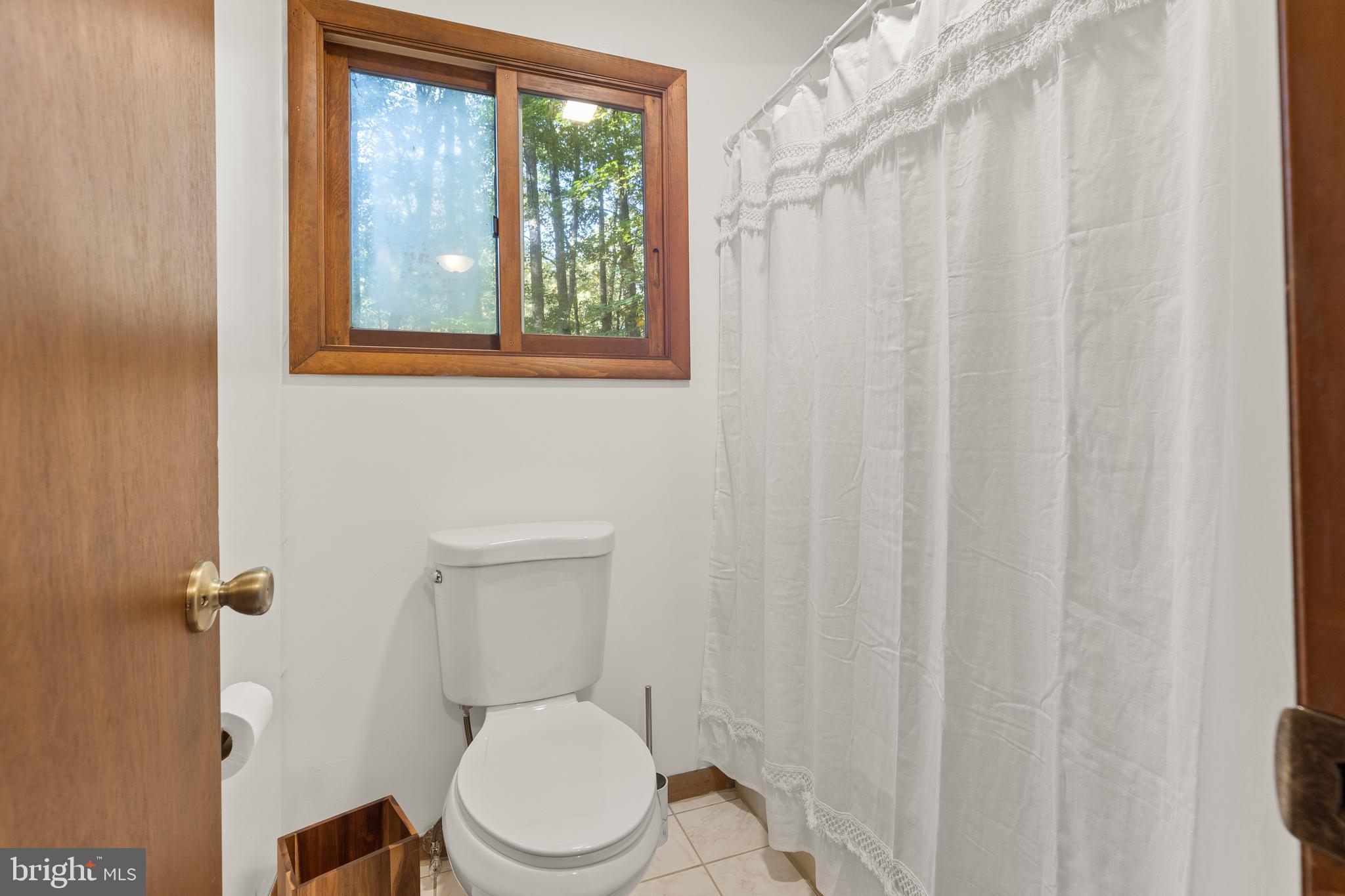 38 Canal Road Ocean Pines, MD 21811 - Photo 24 of 40 a white toilet sitting next to a small window