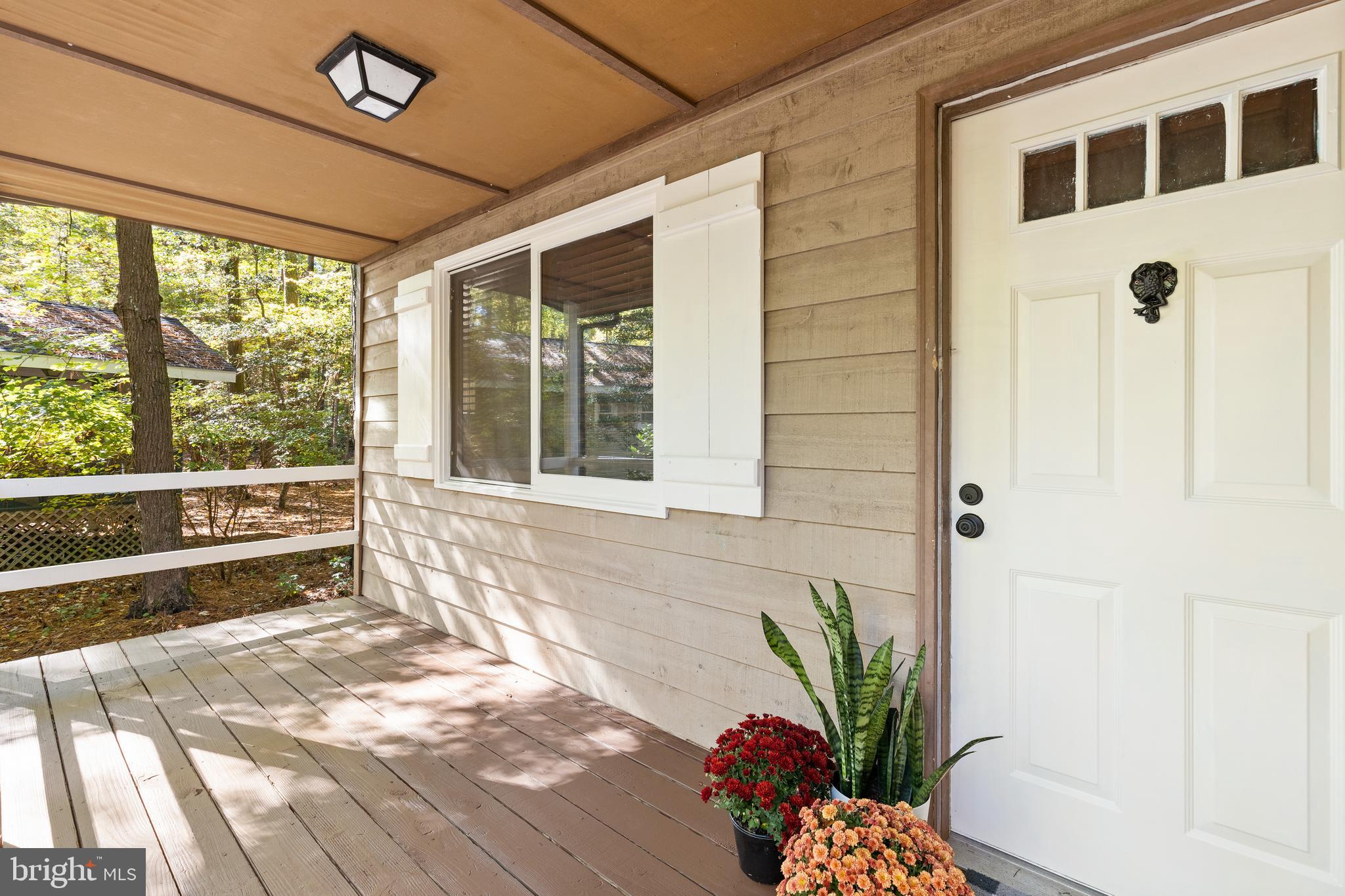 38 Canal Road Ocean Pines, MD 21811 - Photo 4 of 40 a view of a porch with a dining table and chairs