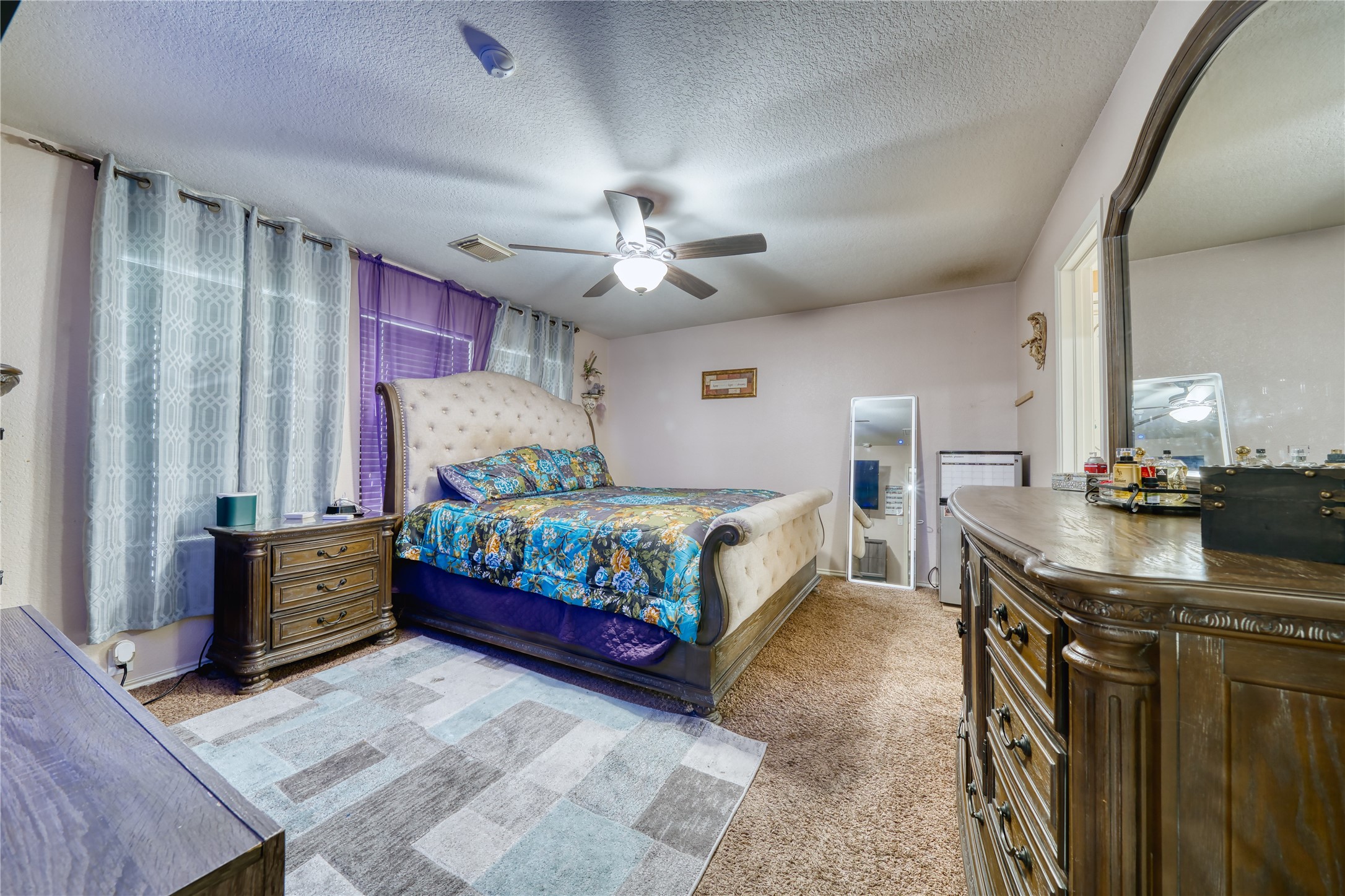 2210 Mountain Ranch Drive Houston, TX 77049 - Photo 21 of 36 a bedroom with a bed and a chandelier