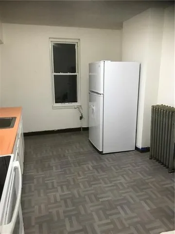 a view of a room with a refrigerator
