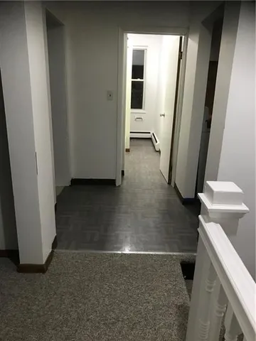 a kitchen with stainless steel appliances a refrigerator sink and white cabinets