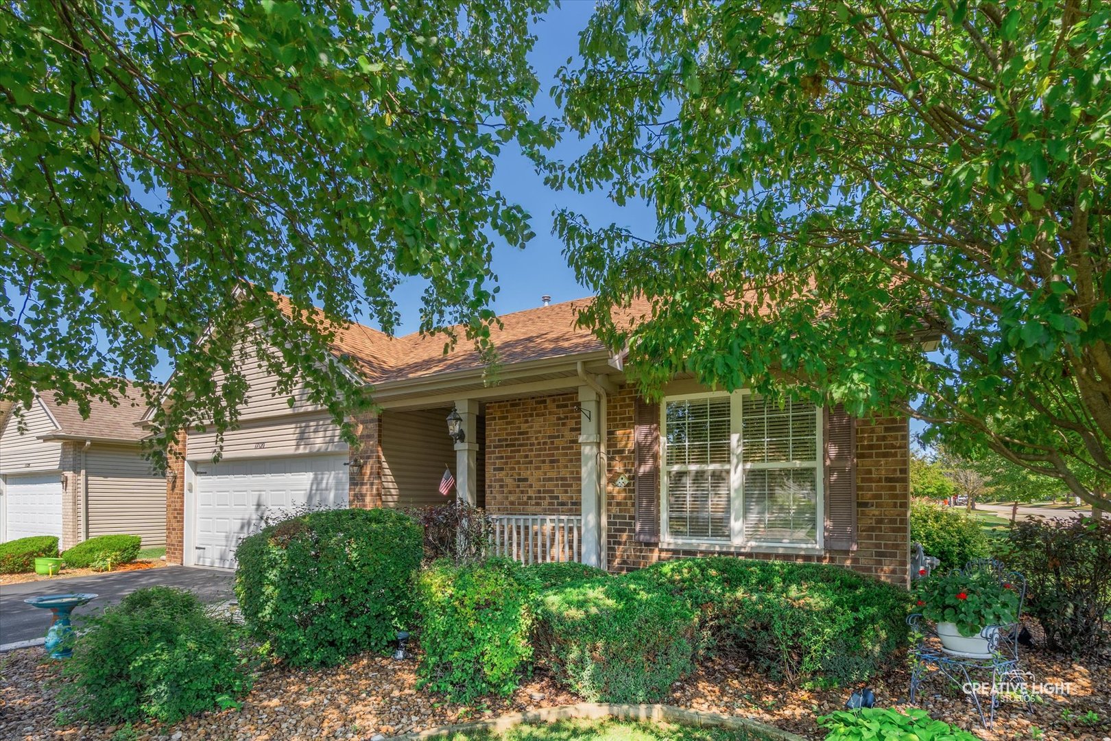 a front view of a house with a garden