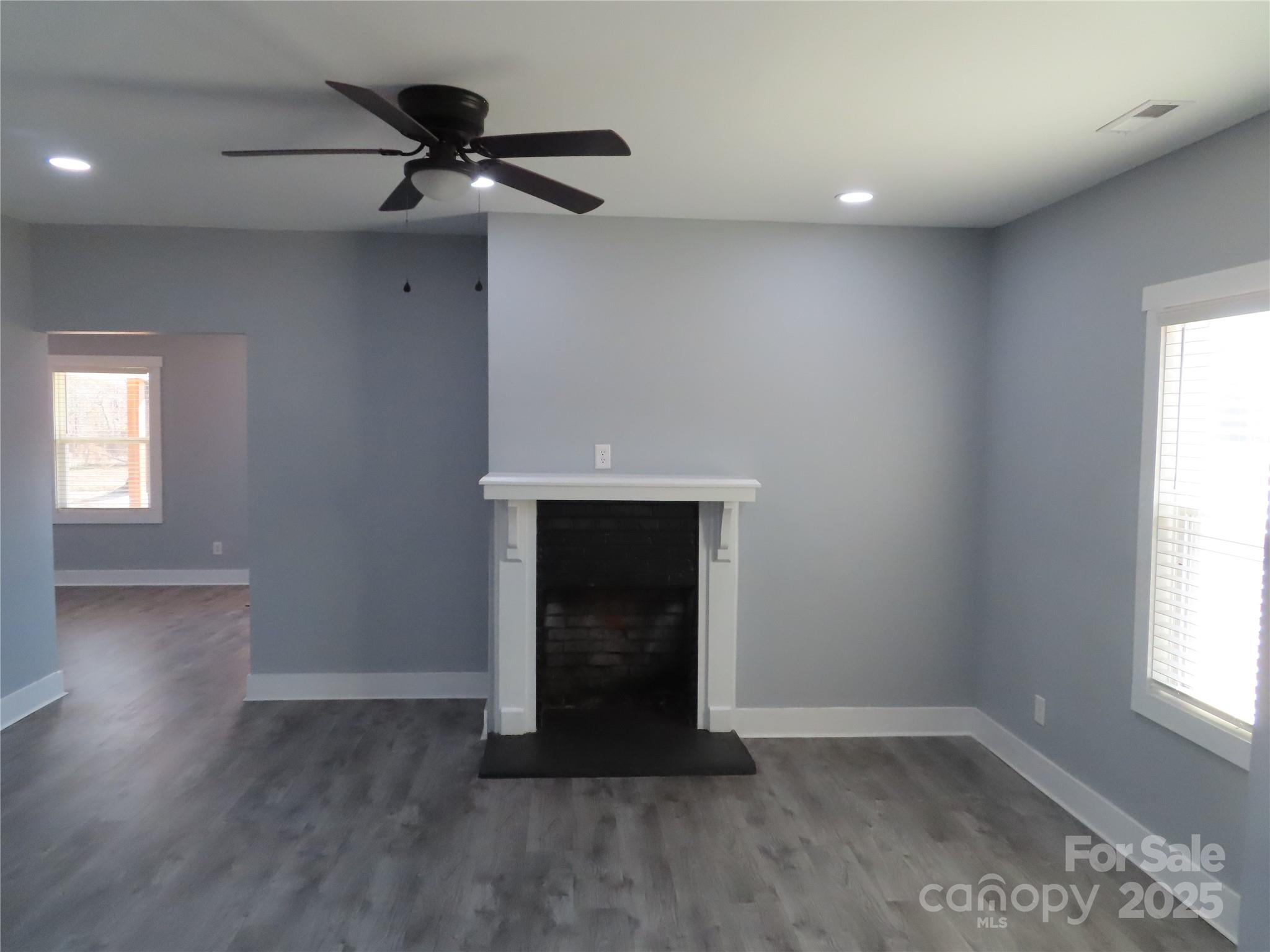 605 State Road 182 Chester, SC 29706 - Photo 15 of 32 an empty room with wooden floor a ceiling fan and windows
