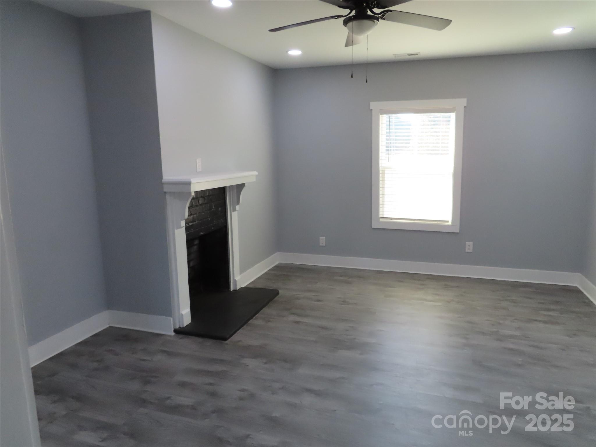 605 State Road 182 Chester, SC 29706 - Photo 17 of 32 an empty room with wooden floor a ceiling fan and a window