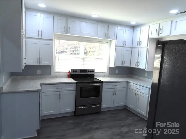 a kitchen with a sink stove and refrigerator