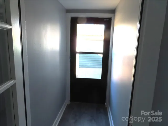 a view of hallway with sink and a window