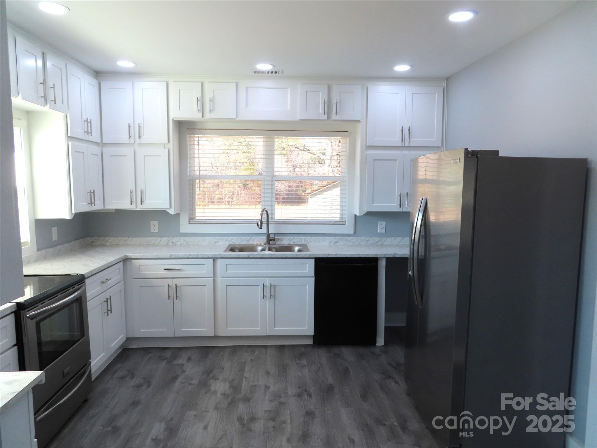 605 State Road 182 Chester, SC 29706 - Photo 31 of 32 a kitchen with stainless steel appliances granite countertop a refrigerator a sink a stove a microwave and wooden cabinets