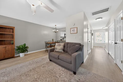 a living room with furniture and a potted plant