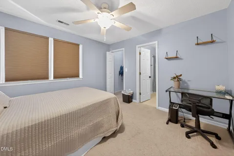 a bed room with a bed and a chandelier