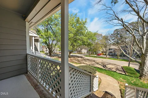 a view of a wooden balcony and trees