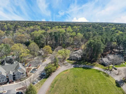 a view of a yard with wooden fence