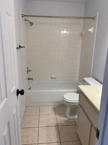 a bathroom with a toilet and shower