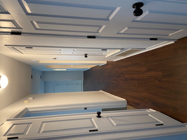 3700 Dustin Court, Unit B Killeen, TX 76549 - Photo 21 of 22 Hall with a textured wall, a textured ceiling, and dark wood finished floors