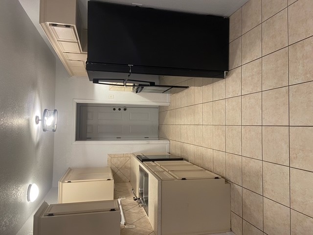 3700 Dustin Court, Unit B Killeen, TX 76549 - Photo 4 of 18 a kitchen with a sink a refrigerator and cabinets