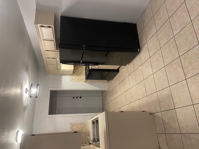 3700 Dustin Court, Unit B Killeen, TX 76549 - Photo 5 of 18 a kitchen with a refrigerator a stove top oven and cabinets