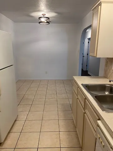 a kitchen with a sink cabinets and utility