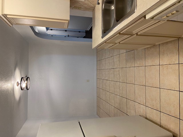 3700 Dustin Court, Unit B Killeen, TX 76549 - Photo 7 of 22 Kitchen featuring white appliances, light countertops, arched walkways, cream cabinetry, and light tile patterned floors