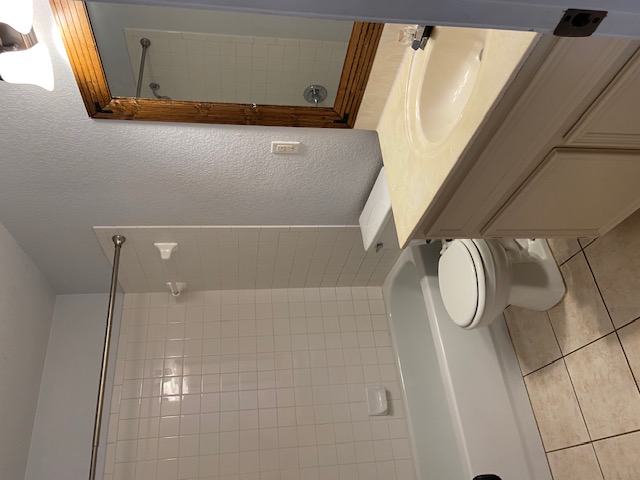 3700 Dustin Court, Unit B Killeen, TX 76549 - Photo 10 of 22 Bathroom with a textured wall, vanity, shower / bath combination, and light tile patterned flooring