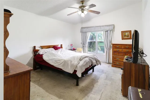 a bedroom with a bed dresser and a window