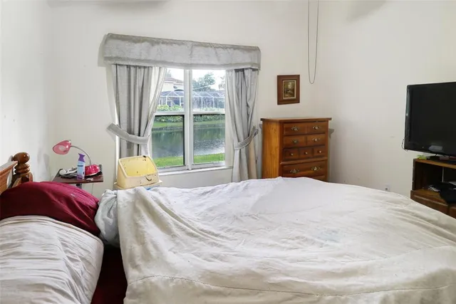 a bedroom with a bed and a television