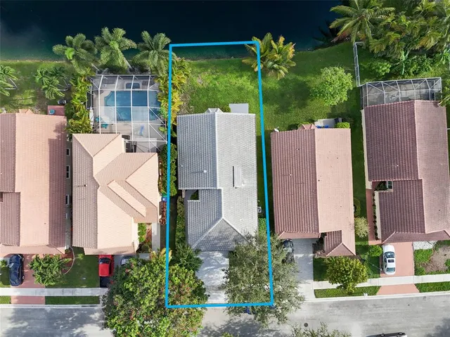 a view of a house with fountain and a garden