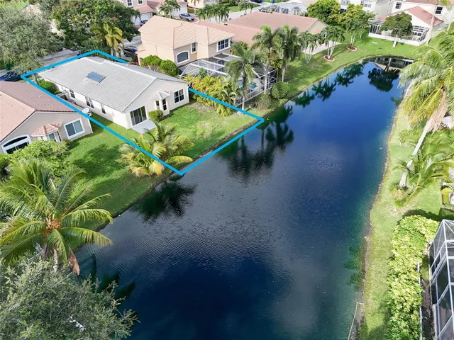 an aerial view of residential houses with outdoor space and street view