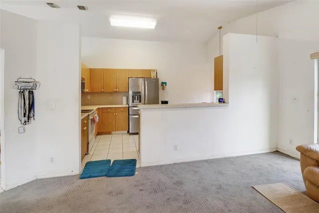 a kitchen with a sink and a refrigerator
