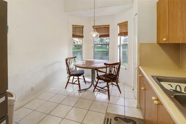 a view of a dining room with furniture and a window