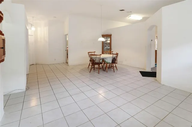 a view of a room with a table and chairs