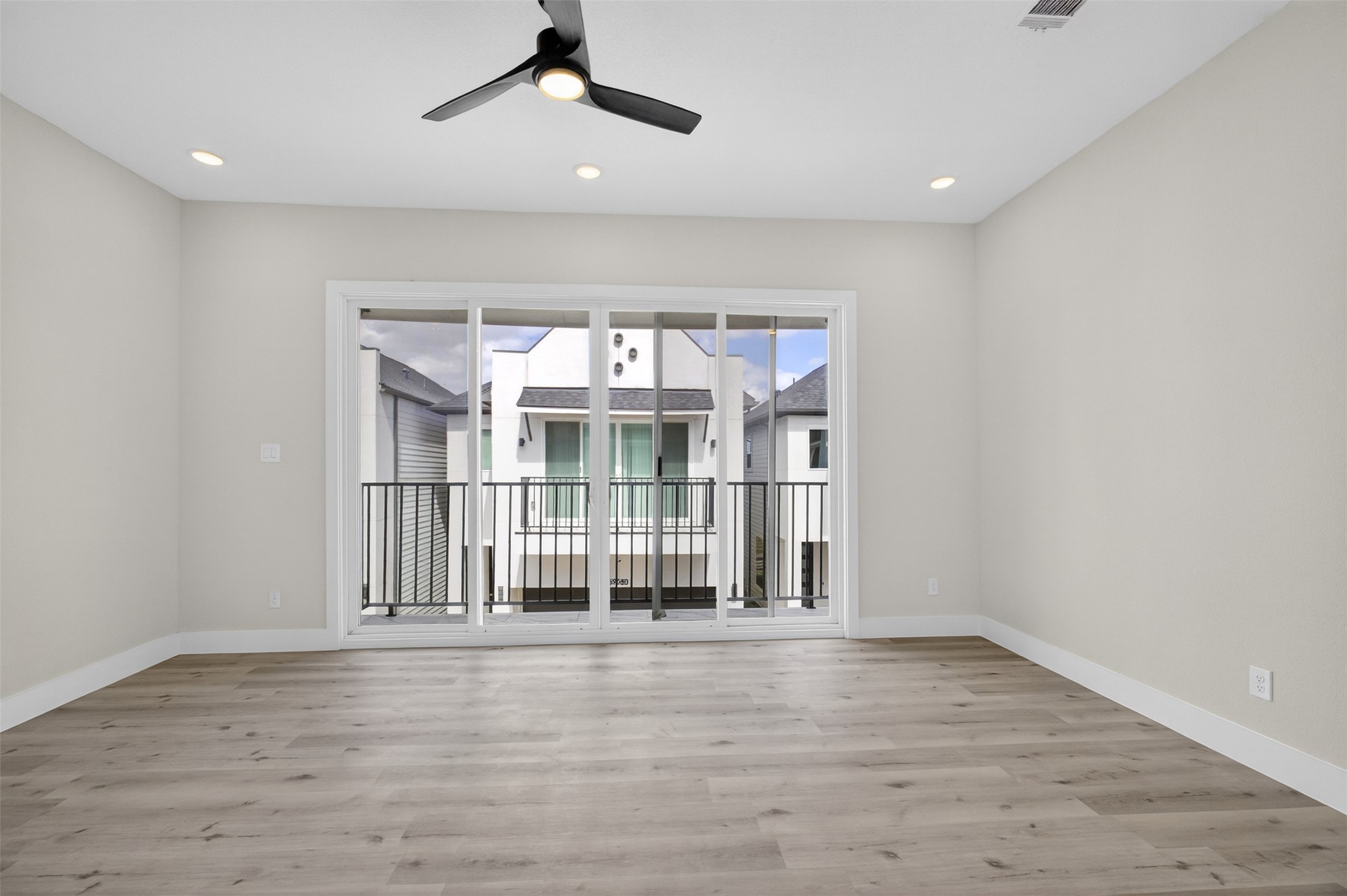5906 St Augustine Street, Unit F Houston, TX 77021 - Photo 15 of 34 Alternate primary bedroom angle centered on the balcony access and ceiling fan.