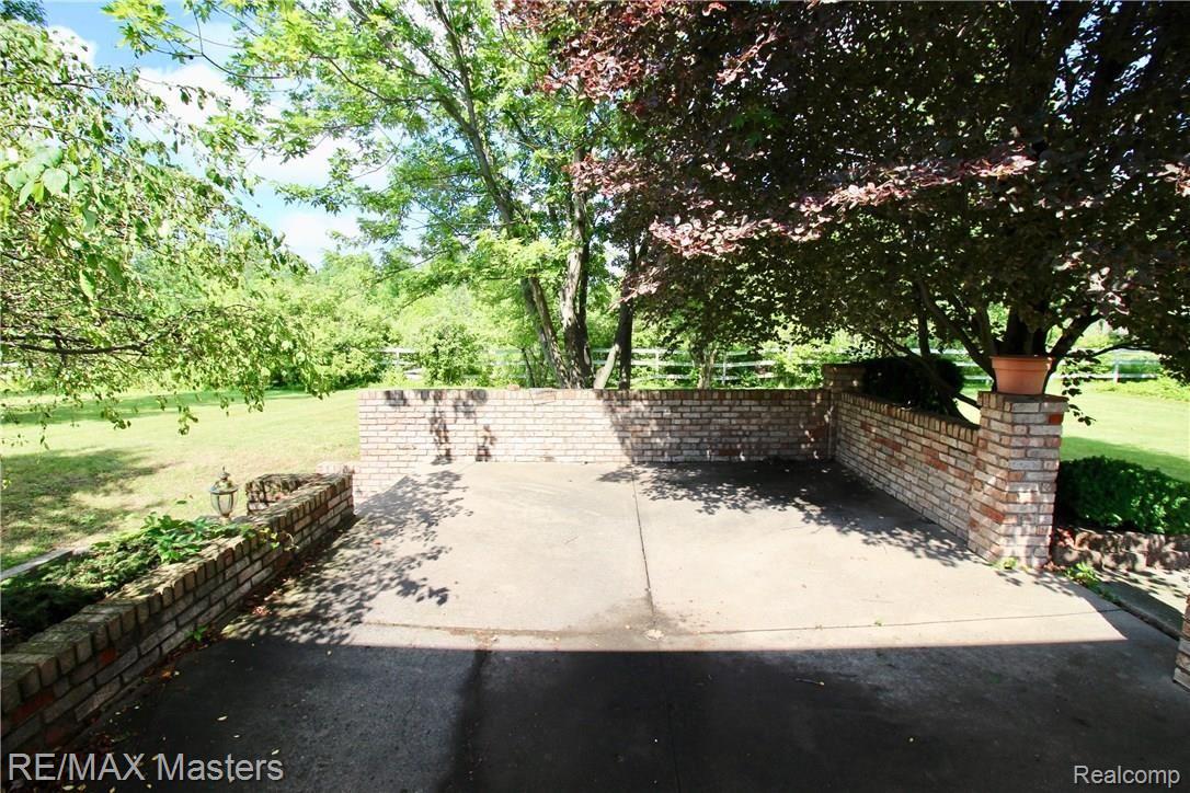 26454 Rinne Road New Boston, MI 48164 - Photo 32 of 41 Outside, the patio gives added space...love the landscaping, the privacy and the room for your outdoor living