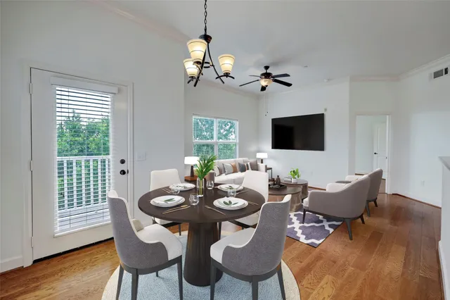 a view of a dining room with furniture wooden floor and chandelier