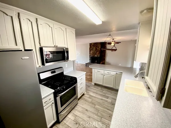 a kitchen with stainless steel appliances a stove a microwave and a refrigerator