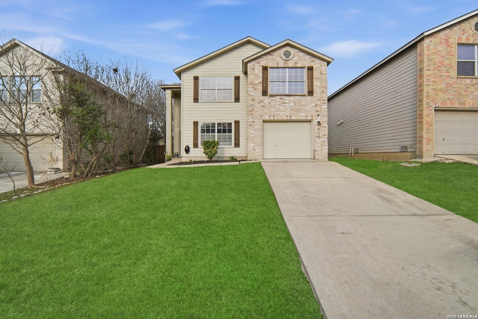 a front view of a house with a yard and garage